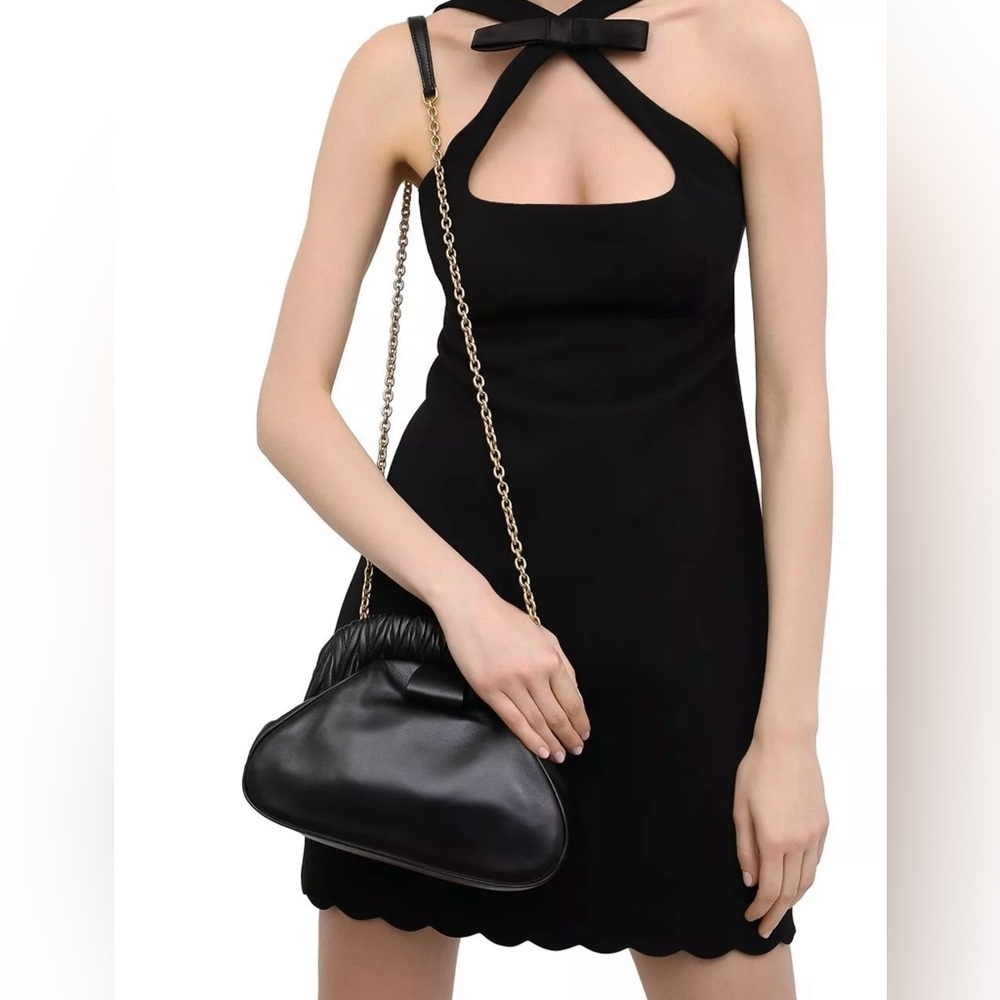 Black Miu Miu clutch mini bag with detachable chain.